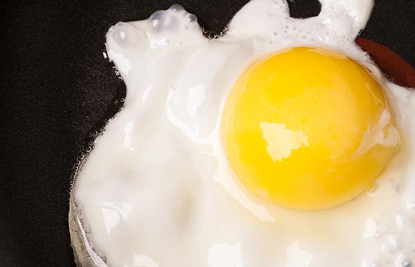 Fried egg with one yolk in pan