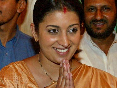 SMRITI IRANI GREETS MEDIA BY CLASPING HER HANDS IN A "NAMASTE" IN NEW DELHI.
