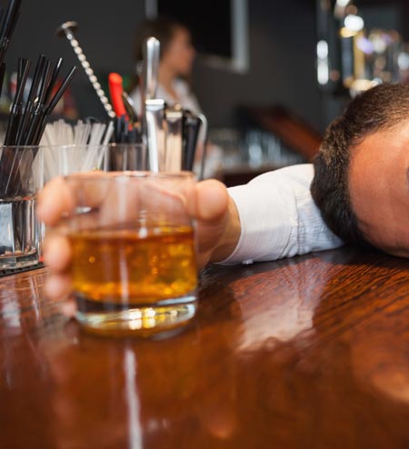 Drunk and unconscious businessman lying on a counter