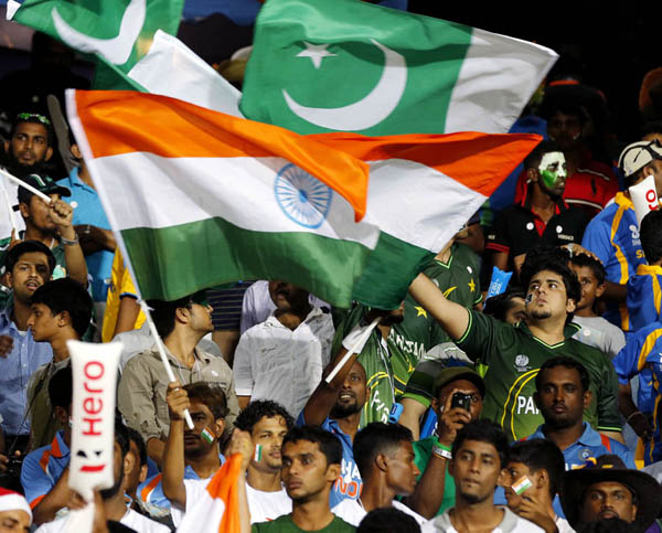 Indian and Pakistan cricket fans wave their national flags during an ICC Twenty20 Cricket World Cup Super Eight match between the two countries in Colombo, Sri Lanka, Sunday, Sept. 30, 2012. (AP Photo/Eranga Jayawardena)