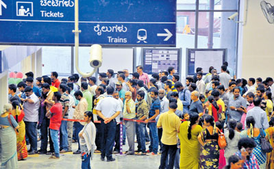 Public waiting for buying tickets for metro ride at Kempegowda station in Bengaluru on Sunday. Photo by B K Janardhan