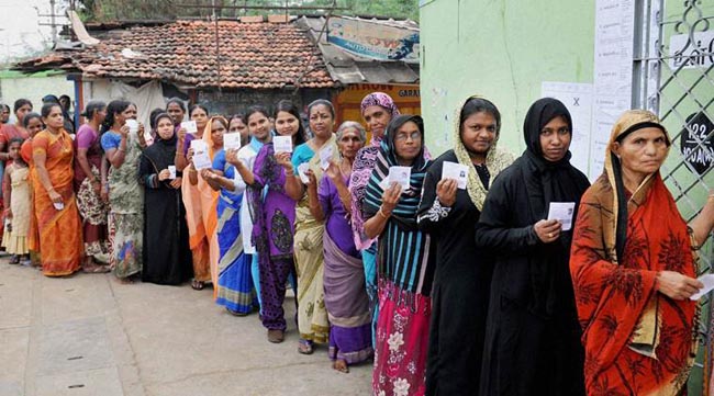 Coimbatore: Women standing in queue to cast their vote during assembly elections in Coimbatore on Monday. PTI Photo (PTI5_16_2016_000060B)